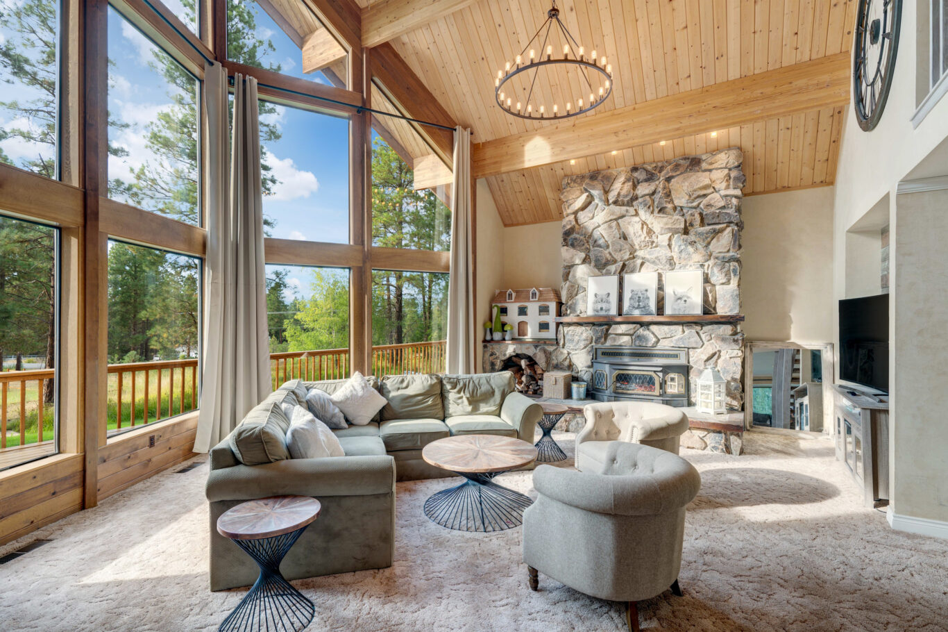 Large barndominium with open staircase and wooden vaulted ceiling.